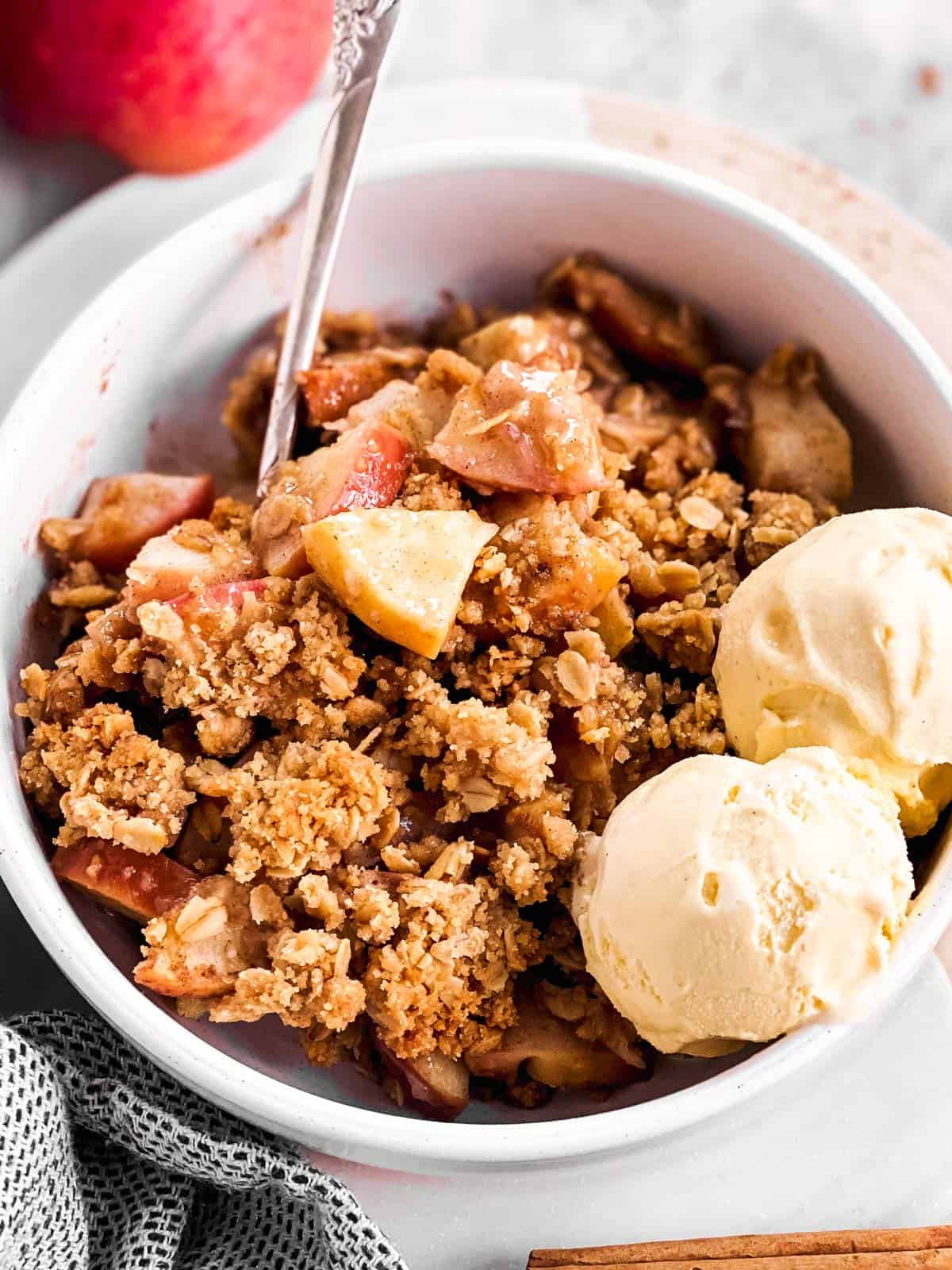 white bowl filled with apple crisp and ice cream