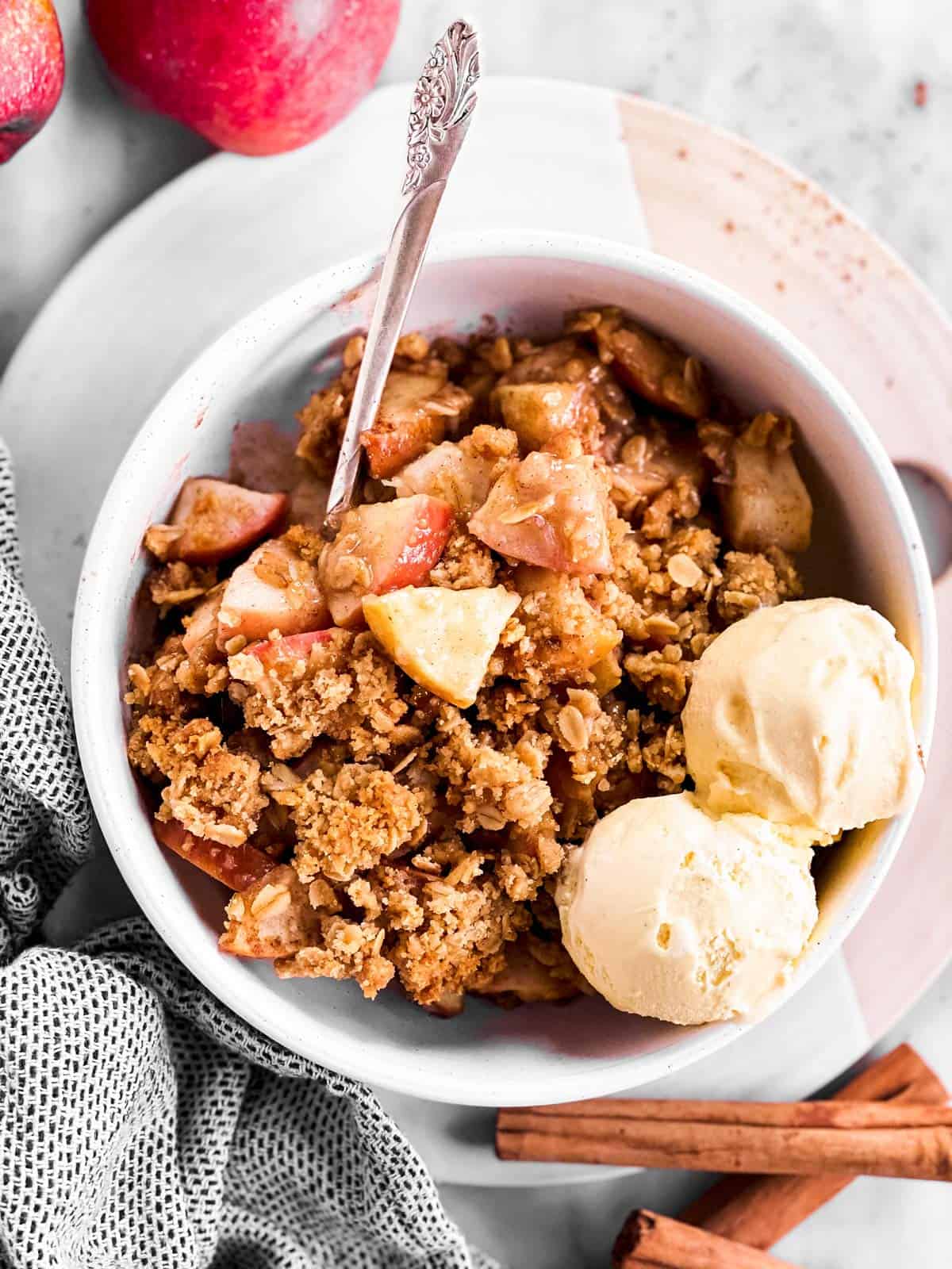 white bowl with apple crisp and ice cream