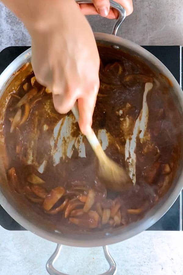 scraping browned bits off the bottom of a skillet deglaze with red wine