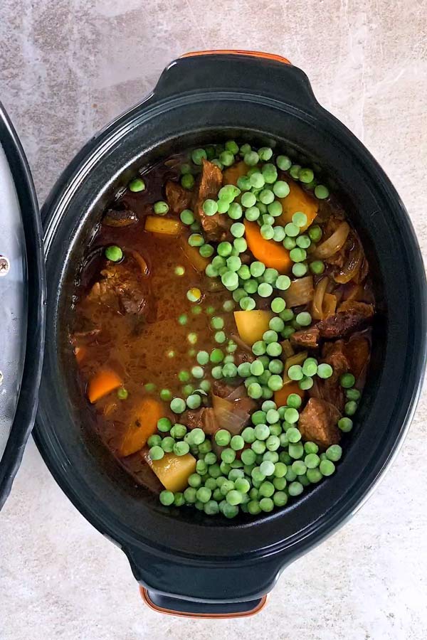 crock pot beef stew after cooking with frozen peas
