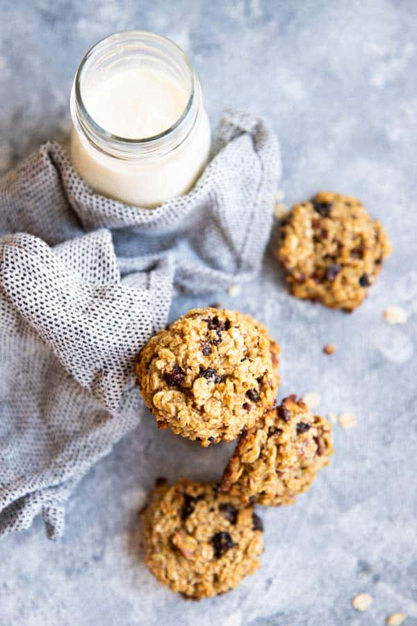 several healthy breakfast cookies on the table with a napkin and a bottle of milk