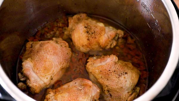 cooked chicken thighs in sun-dried tomato sauce in an instant pot