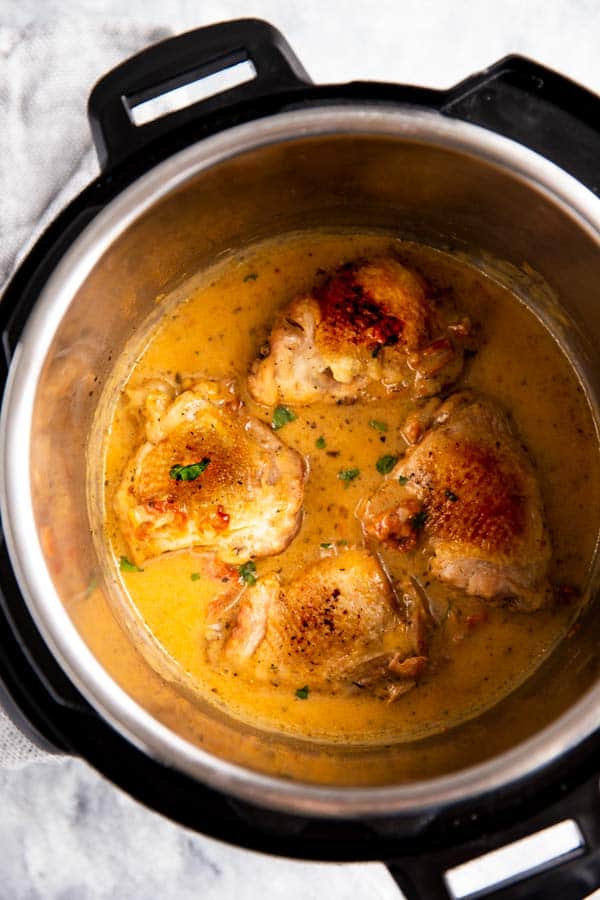 instant pot with chicken thighs in creamy sauce