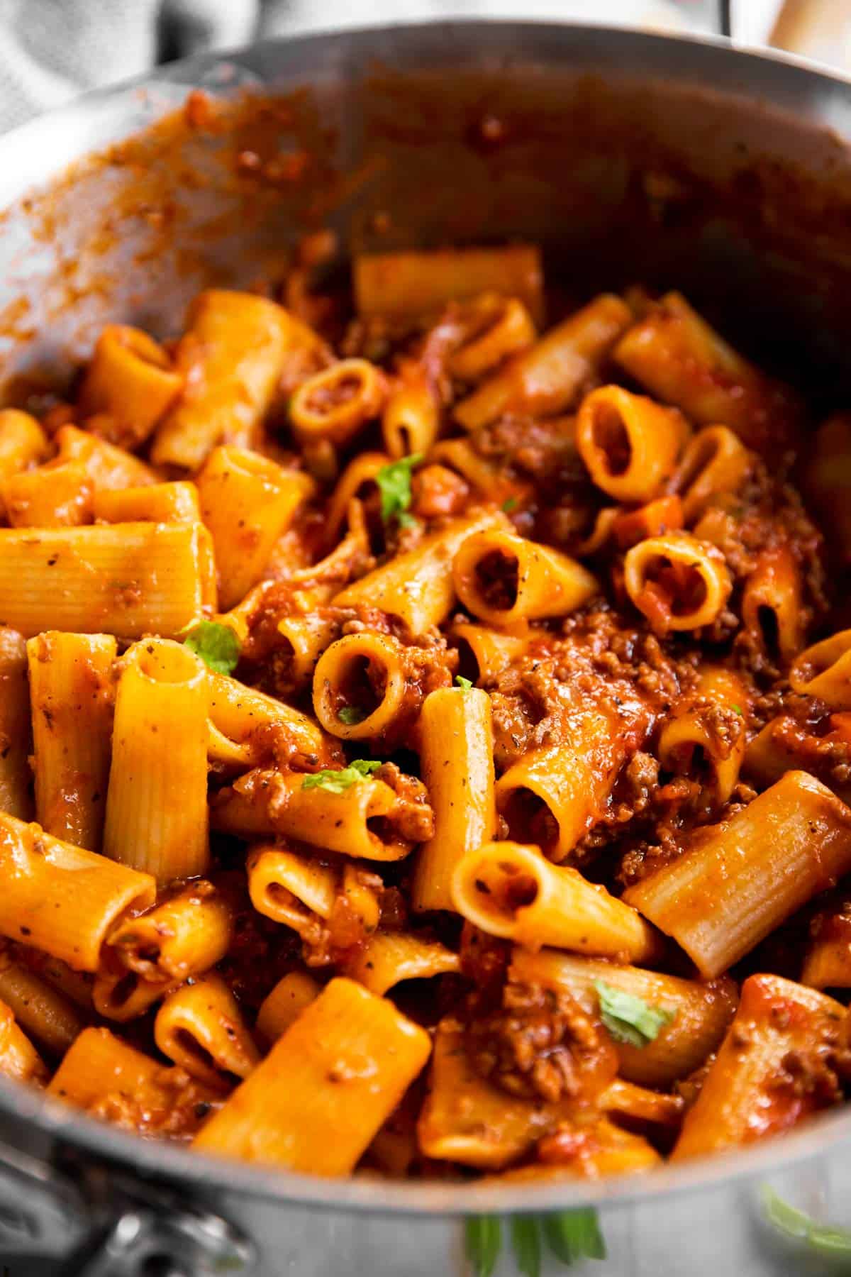 close up of rigatoni bolognese in pan