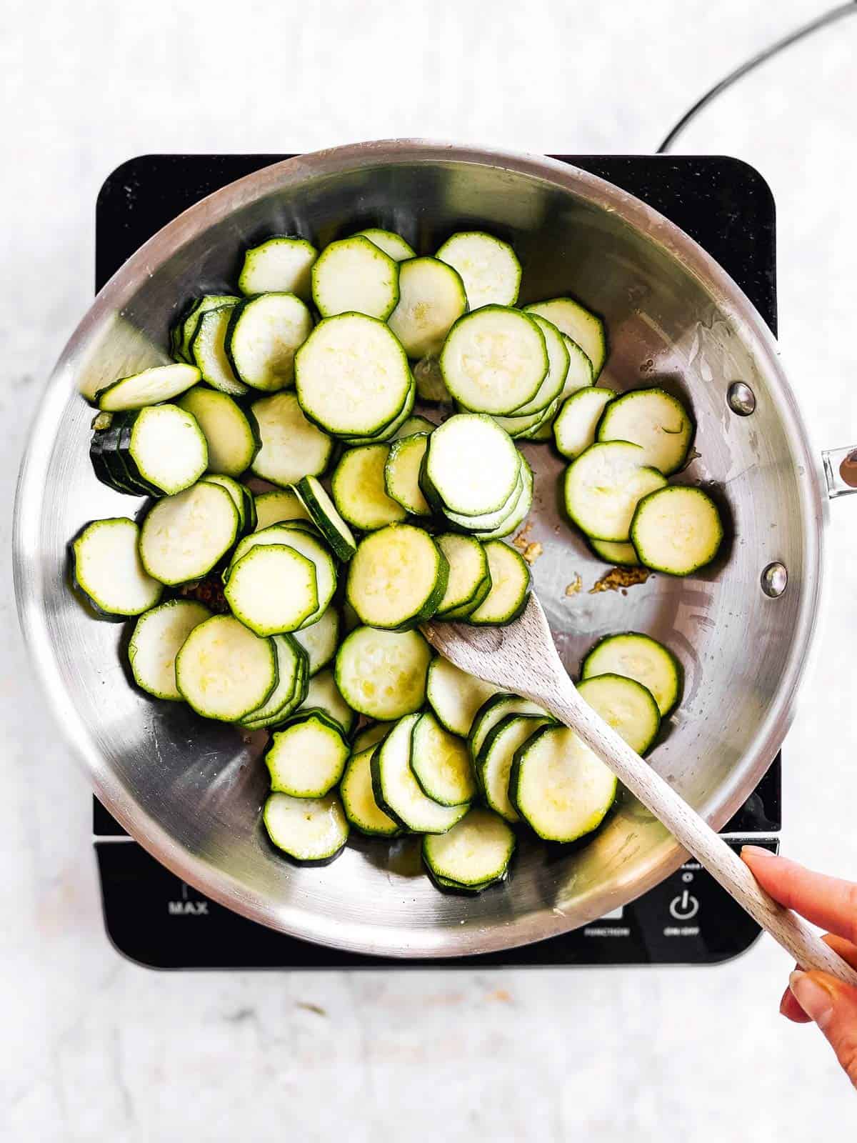 overhead view of raw zucchini slices in skillet