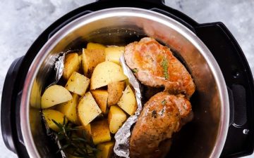 top down view of an instant pot filled with pork chops and potatoes