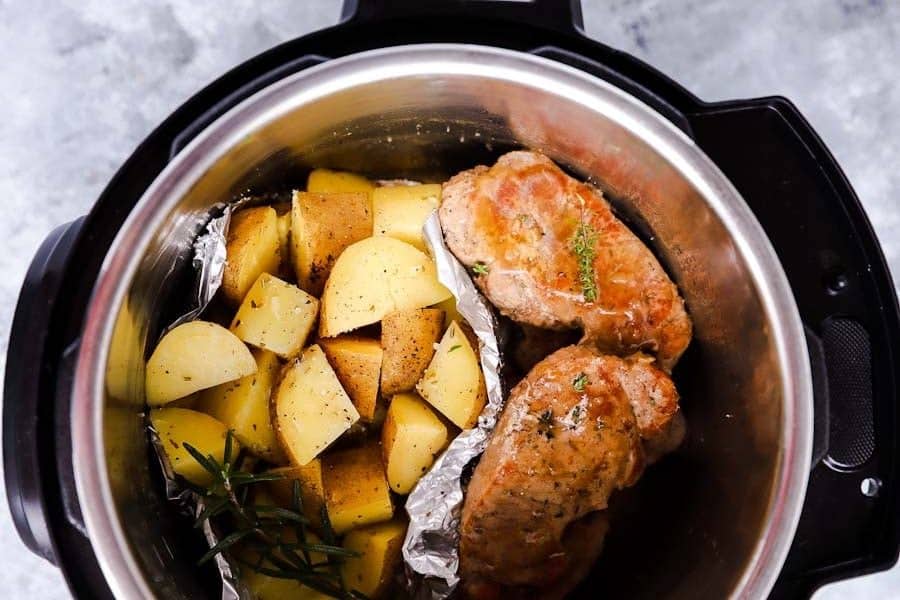 top down view of an instant pot filled with pork chops and potatoes