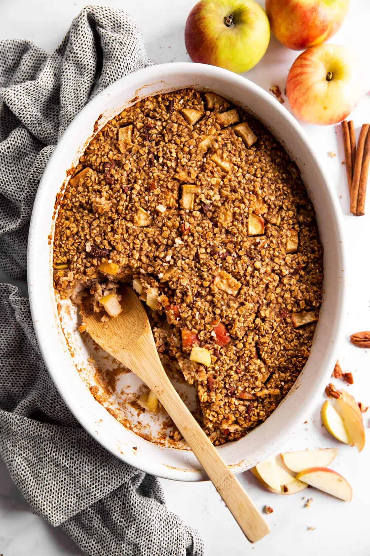 overhead view of white casserole dish with cinnamon apple baked oatmeal