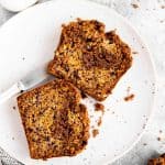 two slices of cinnamon swirl banana bread on a white plate