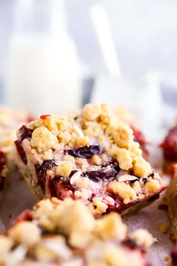 slice of German streusel cake on a board with a bottle of milk in the background