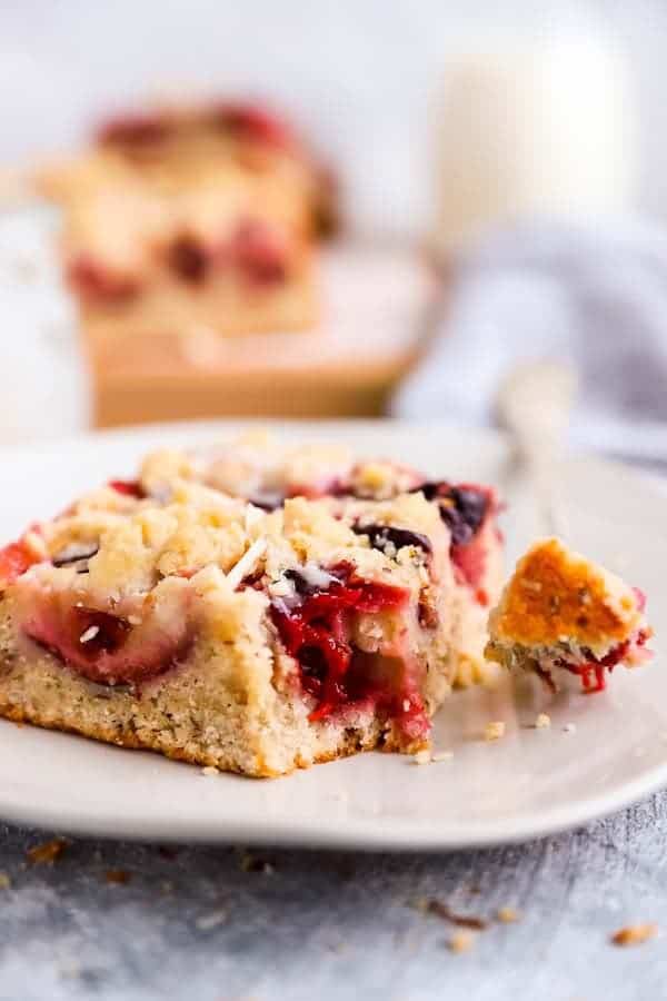 slice of German plum cake on a plate with a fork