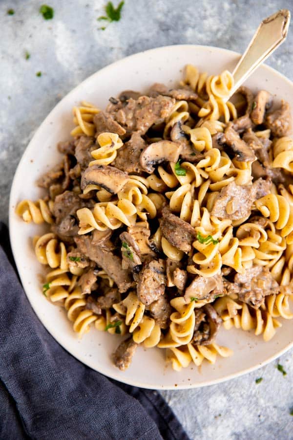 plate with egg noodles and stroganoff sauce