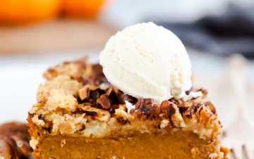 slice of pumpkin dump cake with a scoop of ice cream