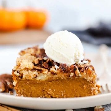 slice of pumpkin dump cake with a scoop of ice cream