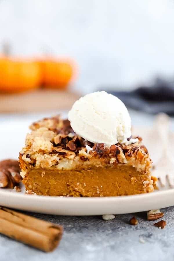 slice of pumpkin dump cake with a scoop of ice cream