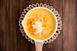 stirring cheese into butternut squash sauce
