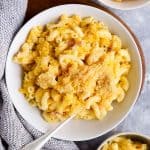 three plates filled with butternut squash mac and cheese