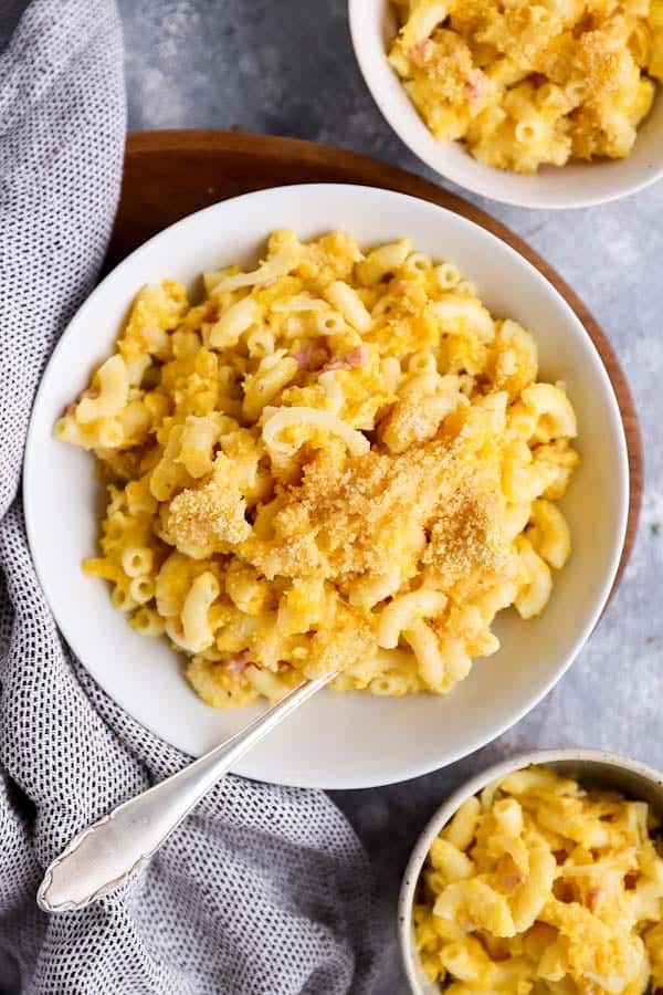 three plates filled with butternut squash mac and cheese