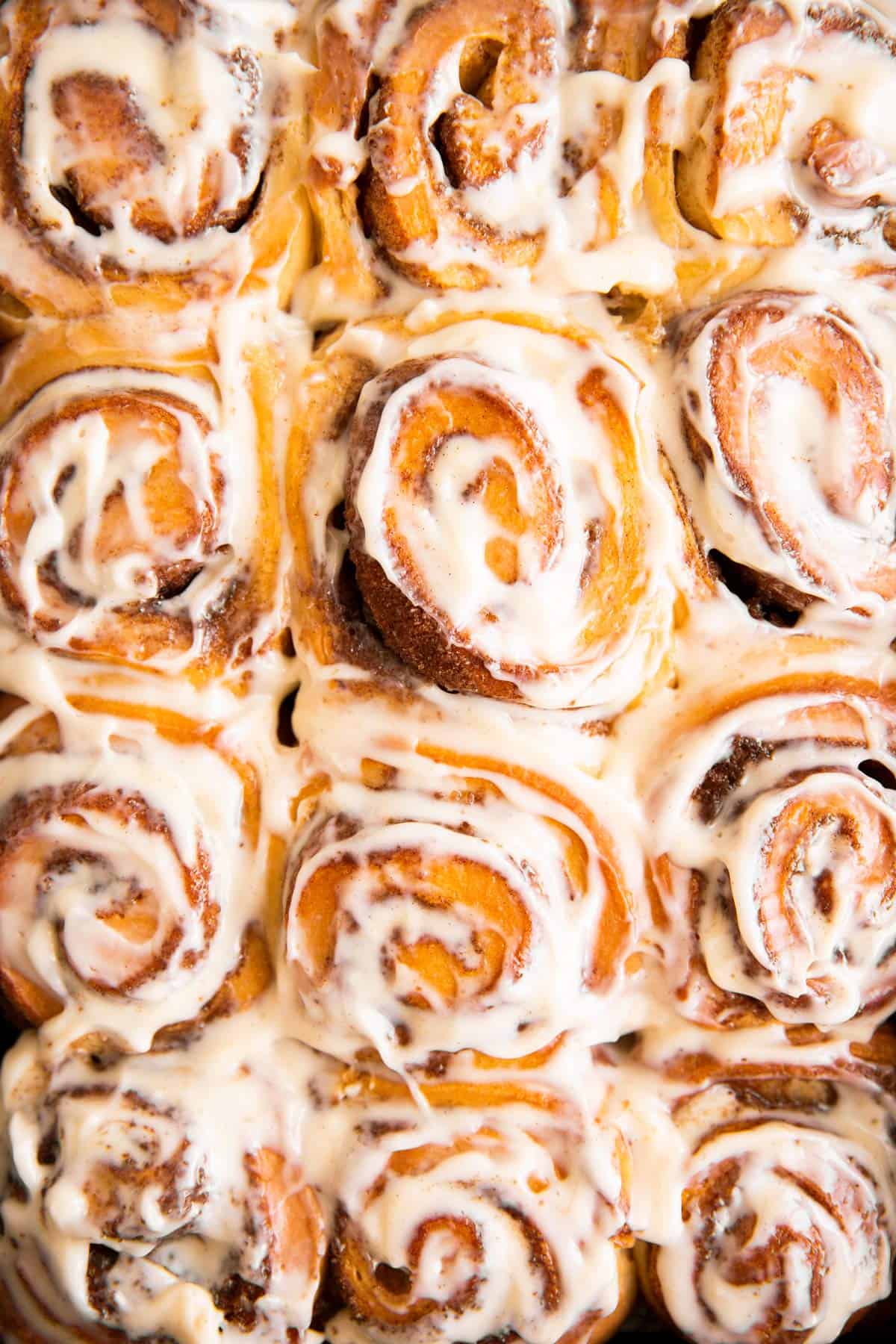 overhead view of frosted cinnamon rolls