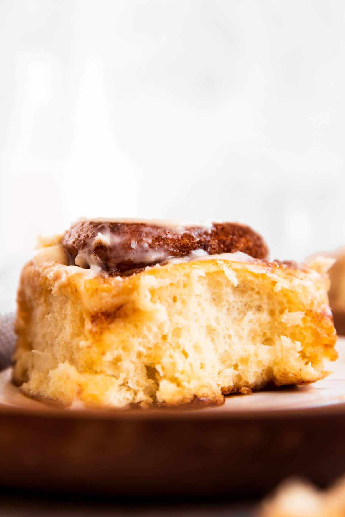 frontal view of cinnamon roll on wooden platter