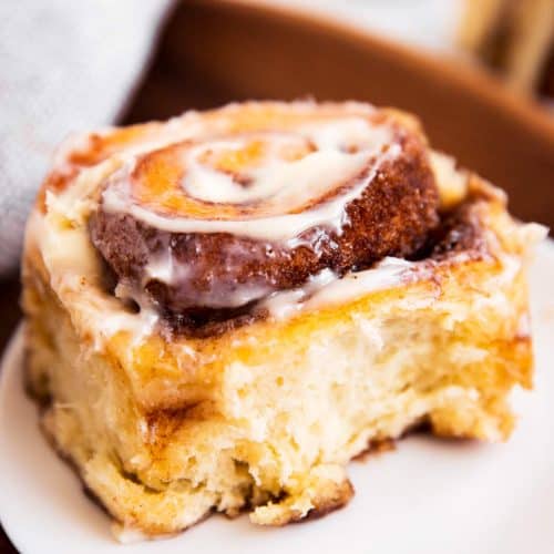 cinnamon roll sitting on white plate