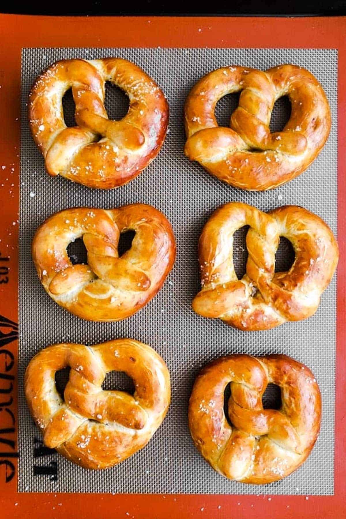 six soft pretzels on silicone baking mat