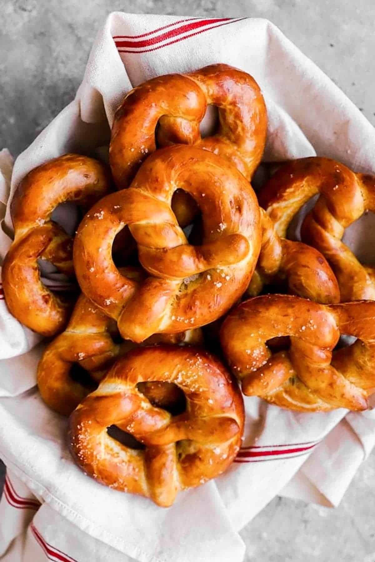 towel lined basket filled with homemade German soft pretzels