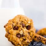 close up photo of a Pumpkin Chocolate Chip Oatmeal Cookies leaning against a milk bottle