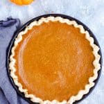 pumpkin pie in a black pie dish