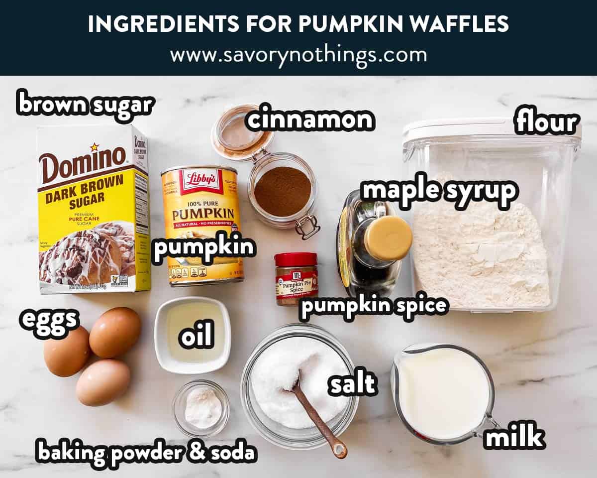 ingredients to make pumpkin waffles on a marble surface with text labels