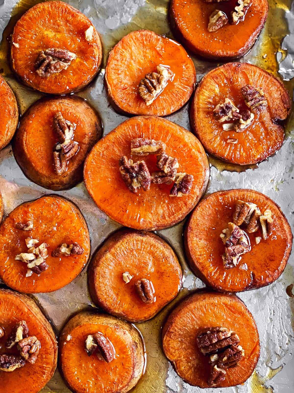 sheet pan with sliced roasted sweet potatoes