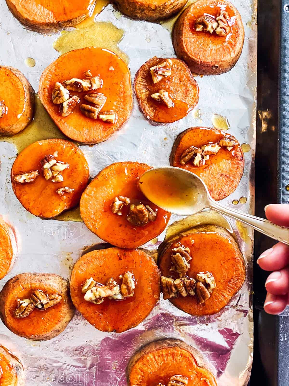 spooning maple topping on sweet potato slices