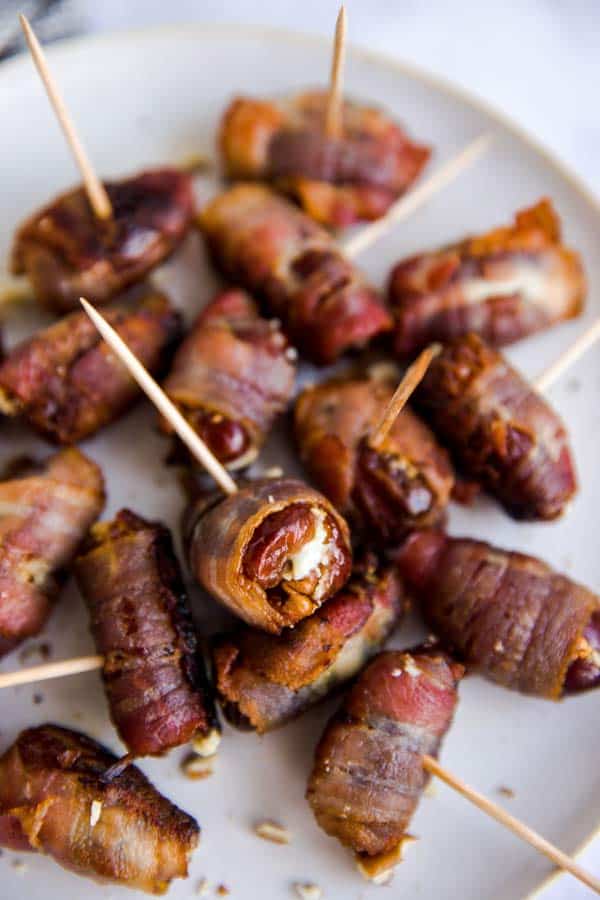 close up photo os a plate with goat cheese stuffed and bacon wrapped dates