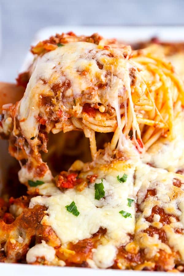 scoop of spaghetti casserole with melted cheese strings
