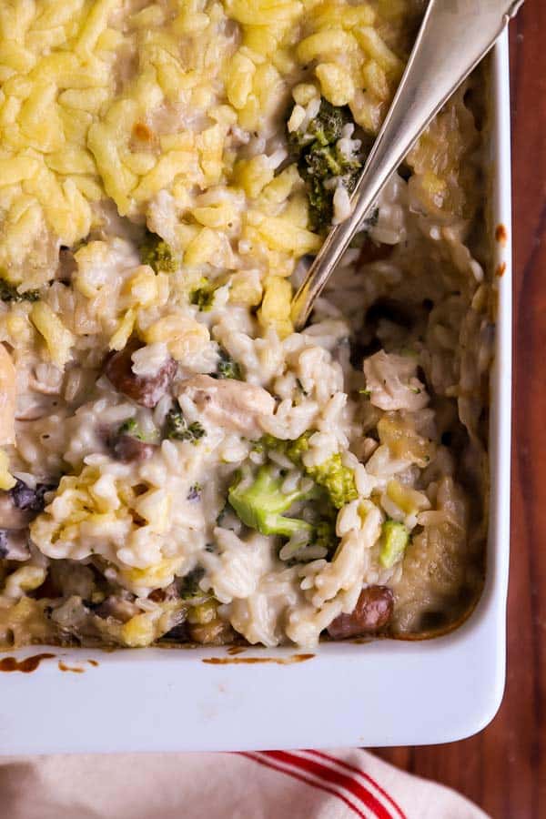 close up photo of a stirred up chicken broccoli rice casserole