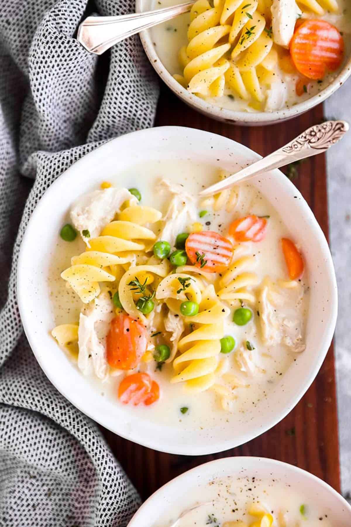 overhead view of chicken noodle soup in white bowl