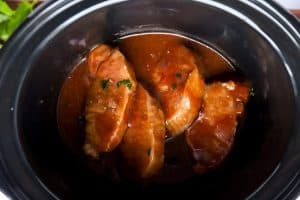 top down view of pork chops in a slow cooker