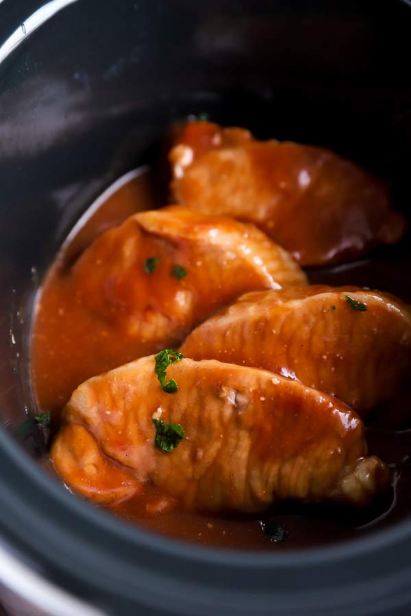 cranberry pork chops in a black crock