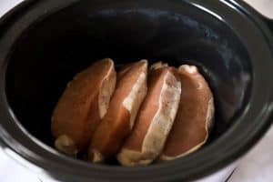 crockpot with raw pork chops inside