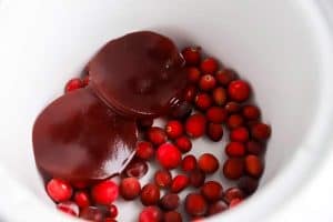 whole cranberries and sliced cranberry sauce in a white crock