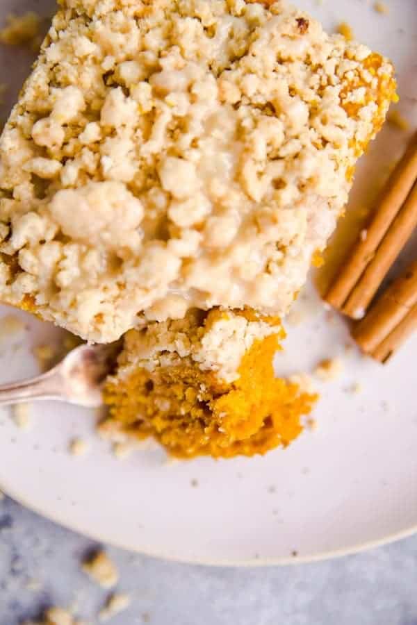 top view of a slice of pumpkin coffee cake on a white plate