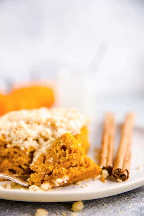 close up photo of a bite taken out of a slice of pumpkin coffee cake