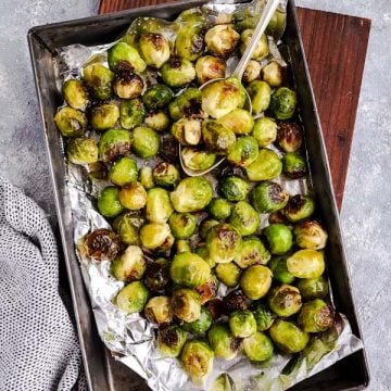 baking pan filled with Brussels sprouts on a wooden board