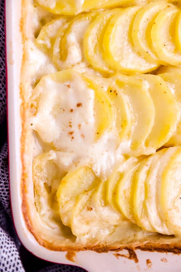 close up photo of scalloped potatoes in a casserole dish