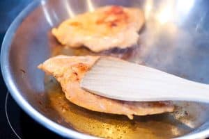 finishing sous vide chicken in a skillet