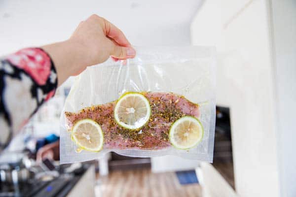 holding up a bag of vacuum packed turkey