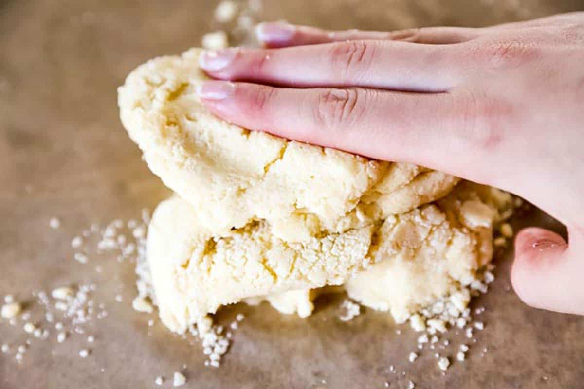 female hand kneading sugar cookie dough