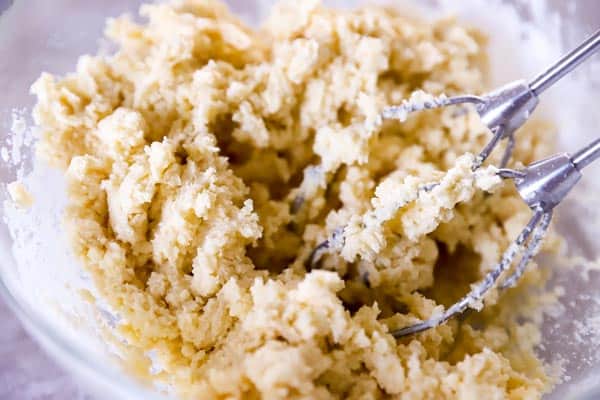 sugar cookie dough in a mixing bowl with beaters