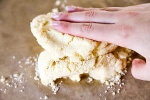 pushing together cookie dough with hand