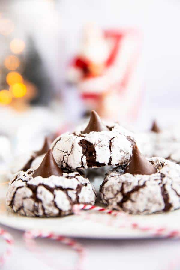 plate with blossom cookies in front of twinkle lights and red ornaments